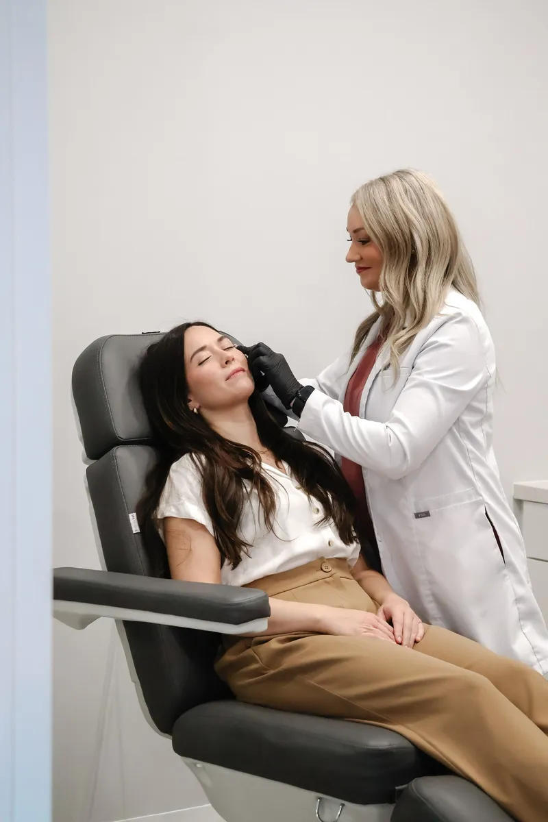 An injector at Modern Medical Aesthetics treating a patient in a treatment chair